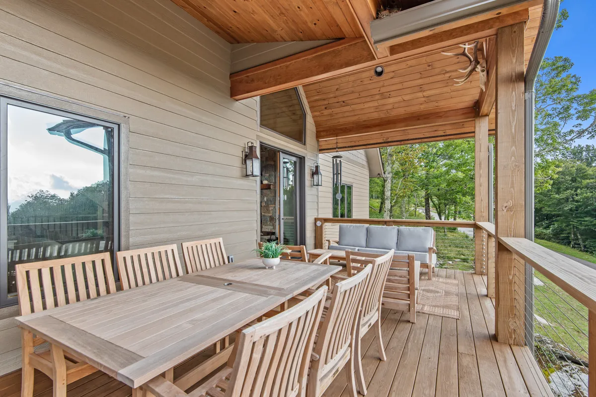 A charming outdoor dining area with a wooden table and ample seating, set amid lush greenery. The space is perfect for morning coffee, sunset dinners, or simply taking in the fresh mountain air and scenic surroundings.